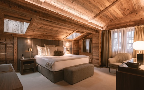 Luxury Chalet Bedroom with Warm Wood Interiors at Ultima Promenade Gstaad