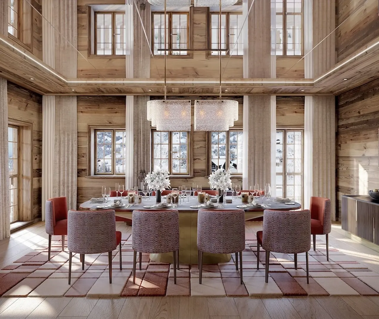 Elegant chalet dining room with wooden walls, large windows overlooking snowy mountains, and a table set for dinner under a modern chandelier.
